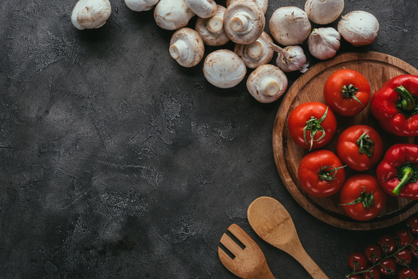 top view of raw tomatoes and mushrooms for pizza on concrete table - Zdjęcie, obraz