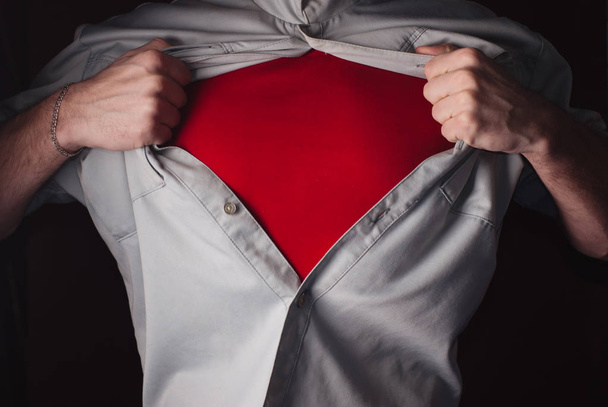 Superhero Tears off his Shirt on a dark Background. - Photo, Image