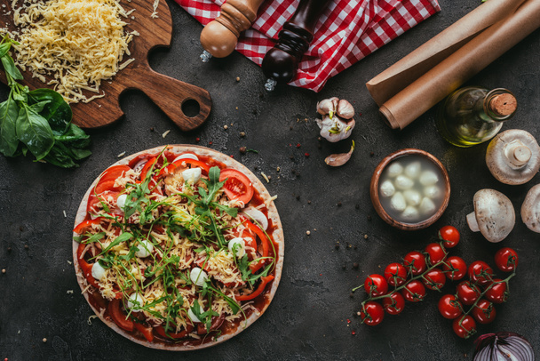 top view of unprepared pizza with ingredients on concrete table - Foto, Imagem
