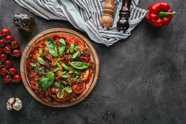 top view of delicious pizza with ingredients on concrete table - Photo, Image