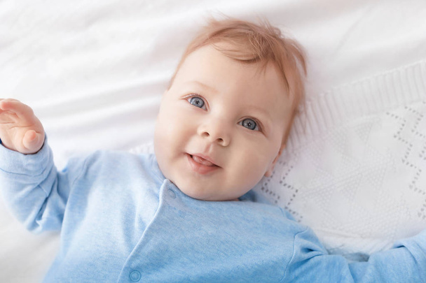Cute little baby lying on bed, top view - Photo, Image