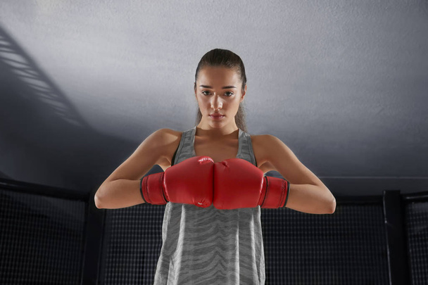 Portrait of young female boxer in gym - Foto, imagen