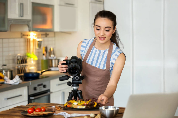 Young woman with professional camera preparing still life composition - Photo, Image
