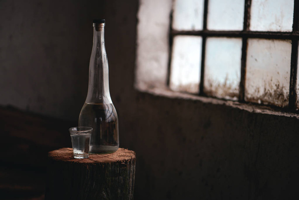 Strong alcohol drink in bottle with shot glass - Φωτογραφία, εικόνα