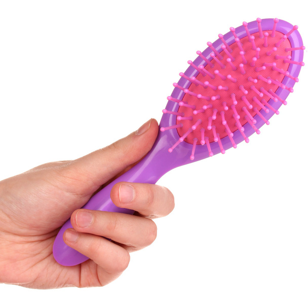 purple hair brush in the hand isolated on white - Foto, Imagem
