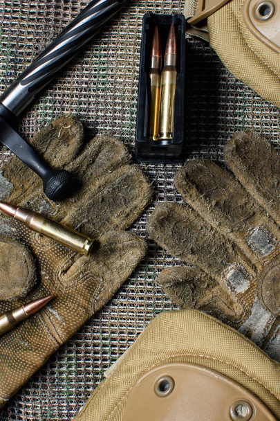 Carbine clip, ammo, gloves  and shutter lies on a background. - Photo, Image