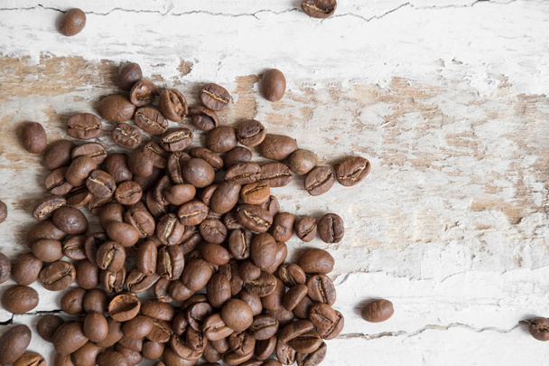 coffee beans scattered on the rough wooden surface background - 写真・画像