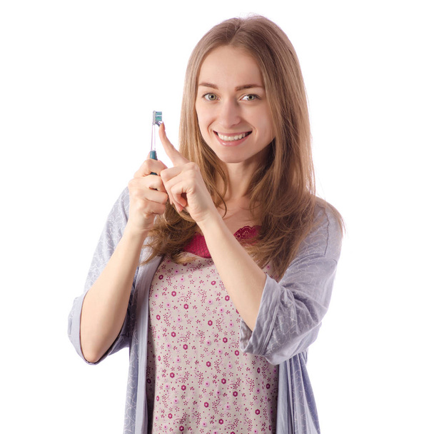 Young beautiful woman in a bathrobe brush for cleaning teeth - Фото, зображення