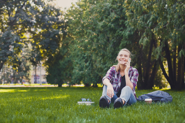 junge Frau telefoniert und lächelt im Freien - Foto, Bild