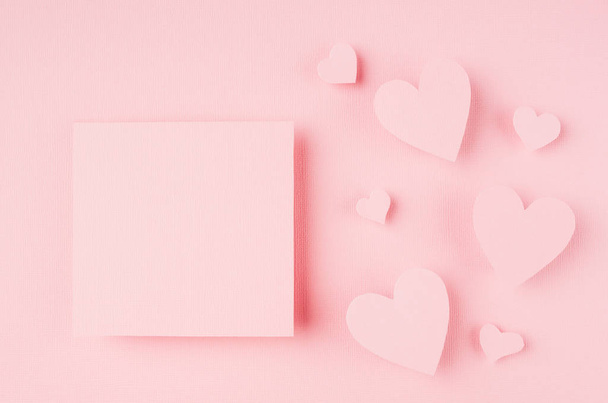 Blank pink sticker with paper hearts on light background. Concept art for Valentine day - Фото, изображение