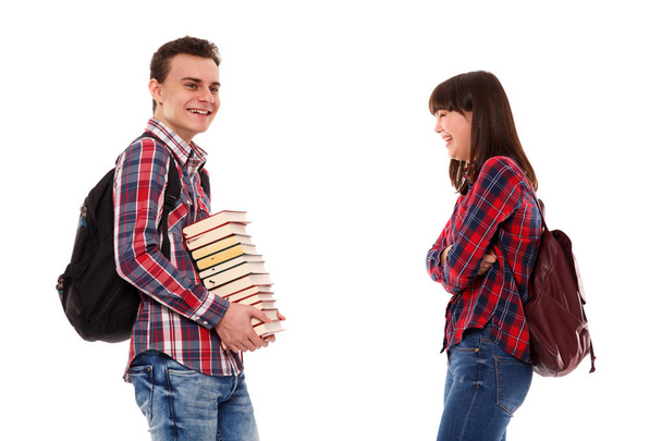 Unhappy teenager holding books while being made fun of - Photo, Image