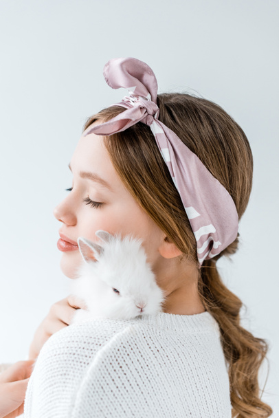 beautiful girl holding cute white rabbit isolated on white - Foto, afbeelding
