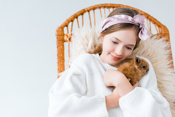 beautiful little girl hugging cute furry rabbit isolated on white - Photo, image
