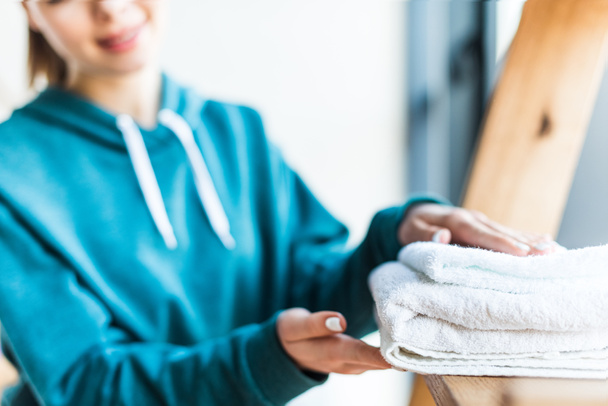 cropped shot of young woman holding clean white towels at home - Photo, Image