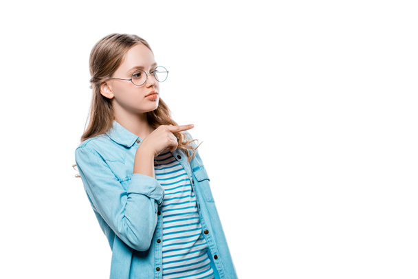 beautiful teenage girl in eyeglasses pointing away with finger isolated on white - Фото, зображення