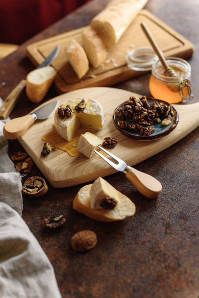 View of delicious meal with brie, walnuts and baguette. - Photo, Image