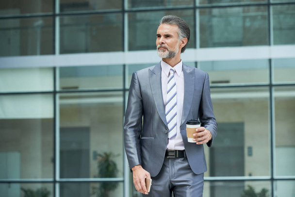Portrait d'homme d'affaires avec café à emporter debout à l'extérieur
 - Photo, image