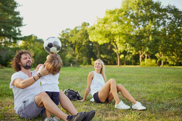 Family playing with a ball in the park.  - Foto, Bild