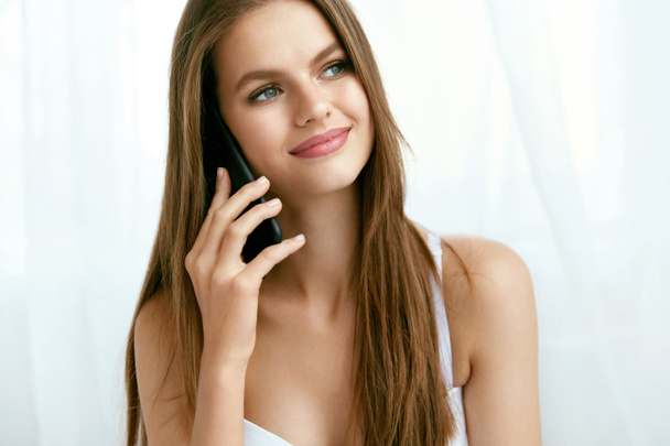 Beautiful Woman Talking On Phone Indoors. - Photo, image