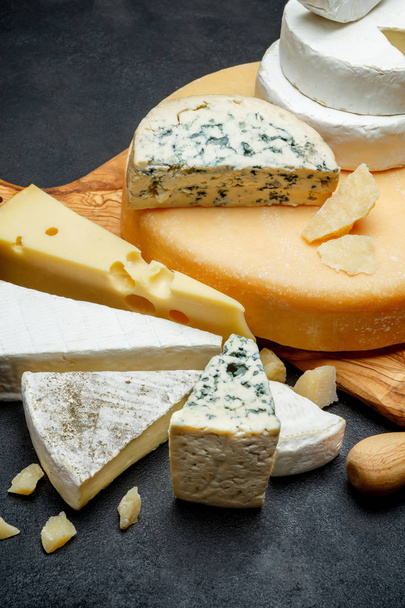 Various types of cheese - parmesan, brie, roquefort, cheddar - Fotó, kép
