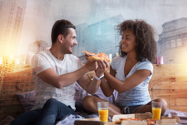 Happy cheerful couple enjoying their pizza - Fotografie, Obrázek