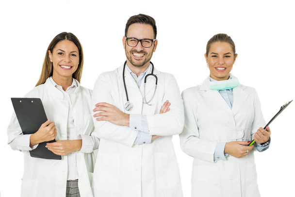 Ritratto di tre medici felici che stanno in piedi e sorridono isolati sul bianco
 - Foto, immagini