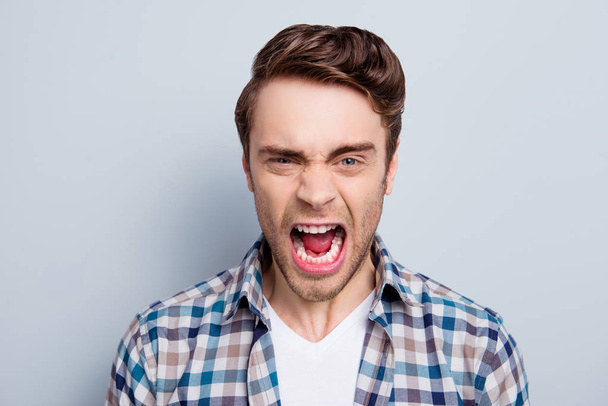 Aggressive man in checkered shirt with wide open mouth is out of - Fotoğraf, Görsel