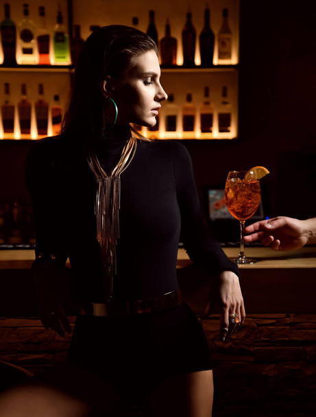 Beautiful sexy fashion brunette woman in bar restaurant relaxing offer orange cocktail  - Fotoğraf, Görsel