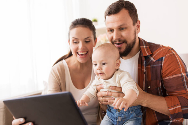 mother, father and baby with tablet pc at home - Foto, Imagen