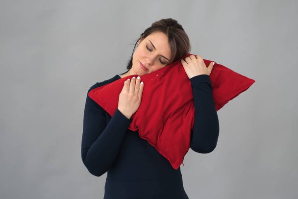 young beautiful girl posing in studio with red pillow standing - Valokuva, kuva