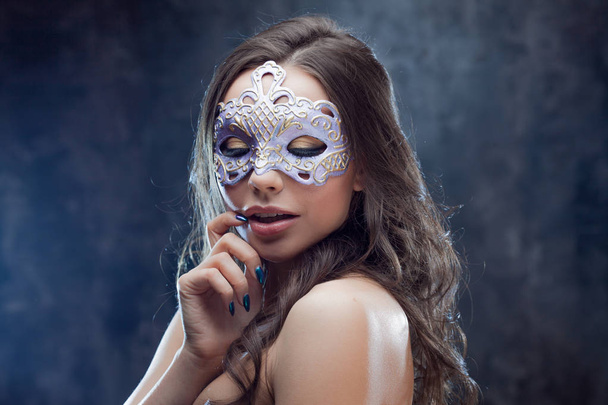 Mysterious and beautiful brunette with Venetian mask. - Valokuva, kuva