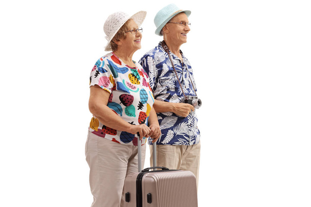 Elderly tourists with a suitcase isolated on white background - Фото, изображение