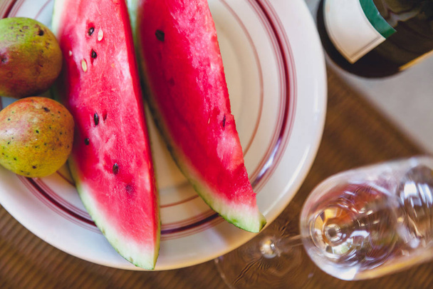 Slices of watermelon and pears lie on plate - Valokuva, kuva