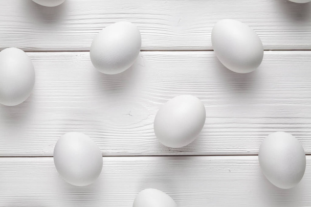 White easter eggs on wooden table - Foto, Imagen