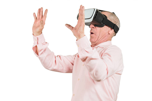 Grandfather is looking at the VR sunglasses, gestures with his hands, isolated on a white background - Photo, Image