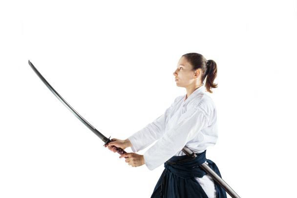 Aikido master practices defense posture. Healthy lifestyle and sports concept. Woman in white kimono on white background. - Фото, изображение