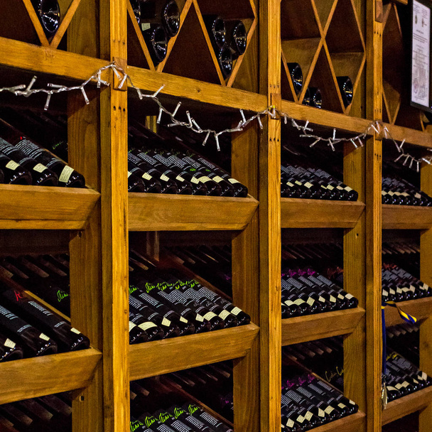 Shelves with wine in the wine store. - Photo, Image