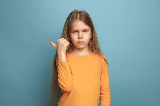 The determination. Teen girl on a blue background. Facial expressions and people emotions concept - Fotoğraf, Görsel