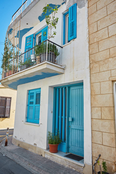 Typical exterior of Greek traditional town street with colorful buildings and marine blue door - Foto, Imagem