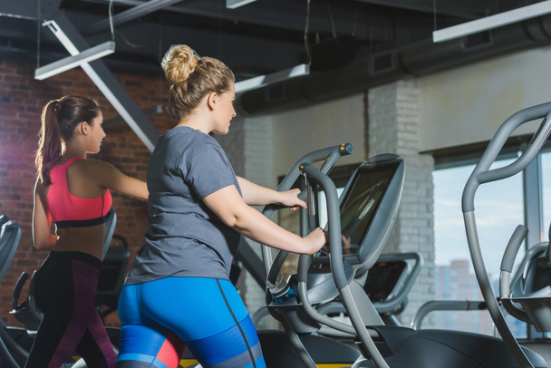 sporty and overweight  women training on treadmills at gym - 写真・画像
