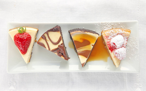 Cheesecake slices with assorted toppings - Photo, Image