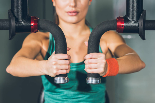 cropped image of sporty woman working out on training apparatus   - Photo, image