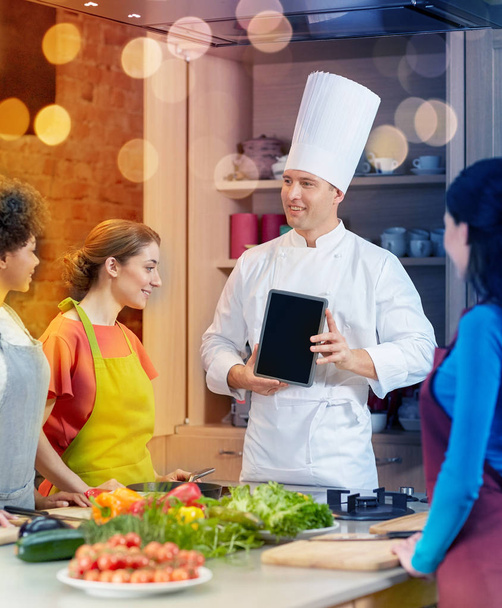 happy women with chef and tablet pc in kitchen - Zdjęcie, obraz
