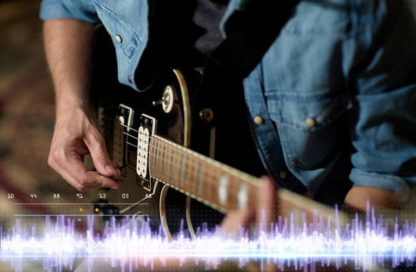 close up of man playing guitar at studio rehearsal - Photo, Image
