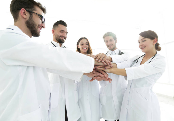 Doctors and nurses in a medical team stacking hands - Foto, afbeelding