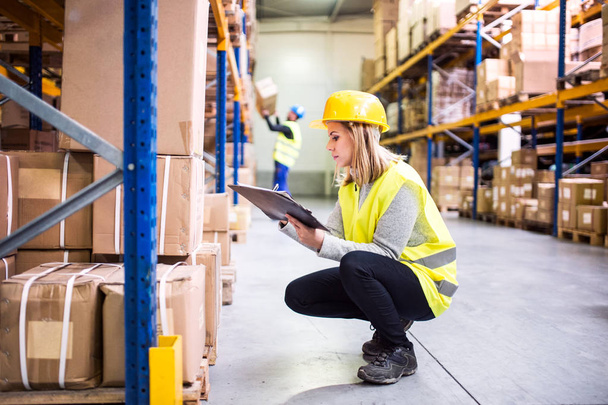 Woman warehouse worker with clipboard. - Photo, Image