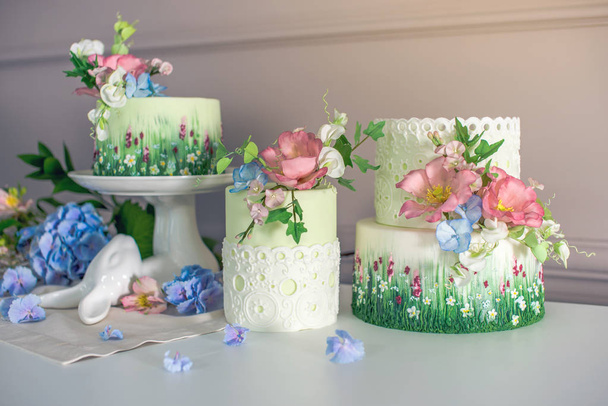 Wedding spring cake decorated with colorful flowers and hydrangeas. Desserts for a festive summer mood - Photo, Image