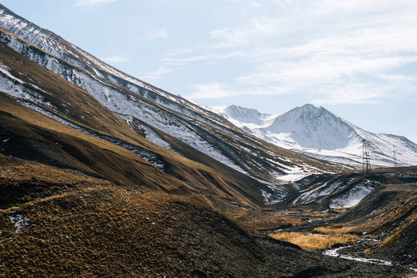 majestic high Caucasian mountains covered with white snow, blue sky - Zdjęcie, obraz