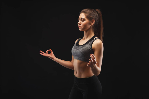 Portrait of young woman working out in studio - Photo, Image