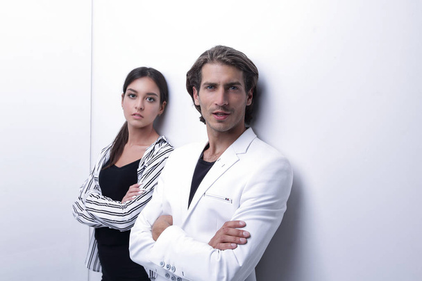 upset couple leaning on a white wall - Foto, immagini
